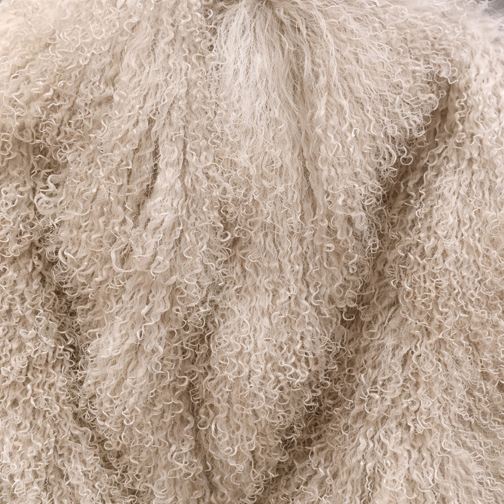 Close-up of beige Mongolian fur coat showing dense curly shearling texture – UK women’s winter outerwear