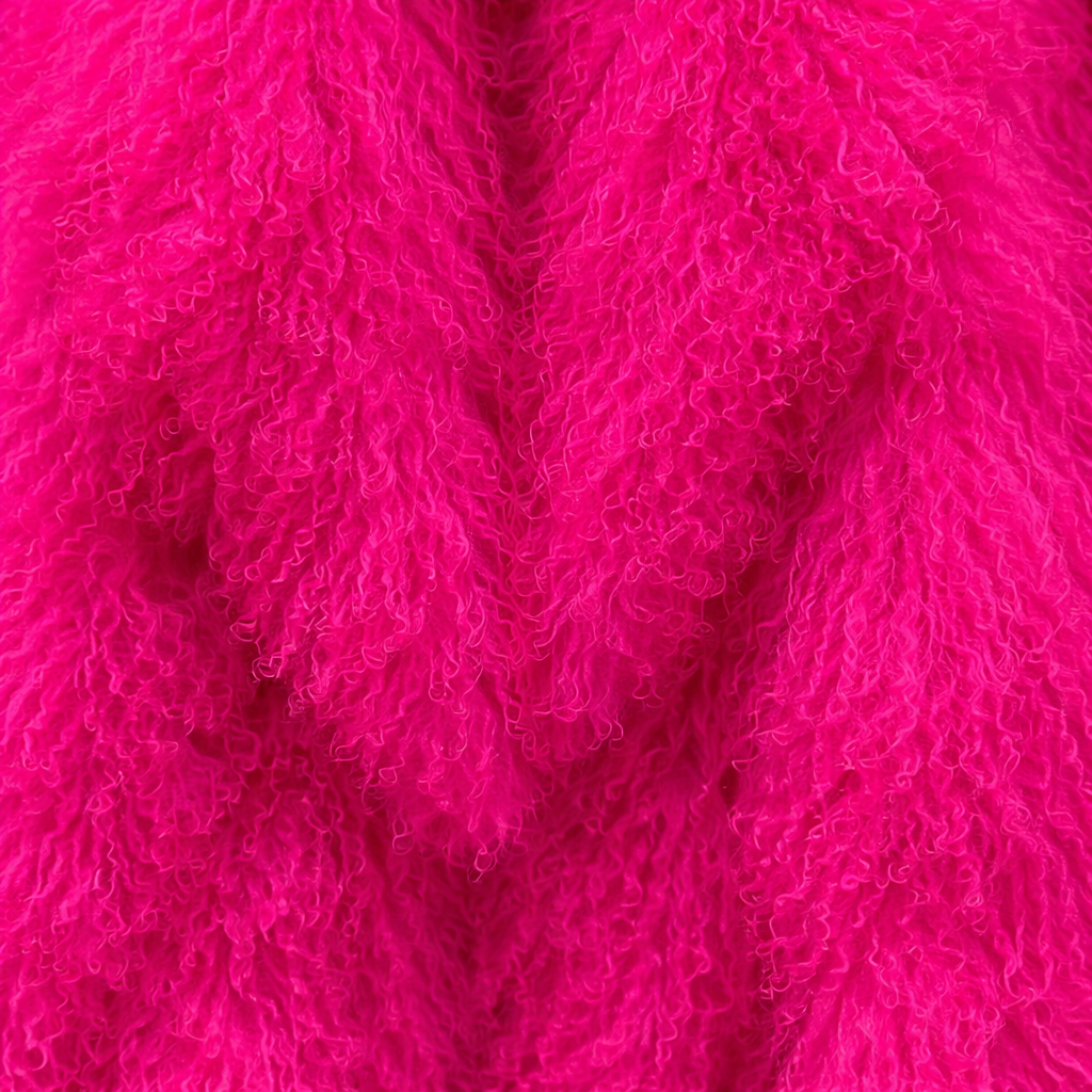 Close-up of bright pink Mongolian fur coat showing dense curly shearling texture – UK women’s winter outerwear