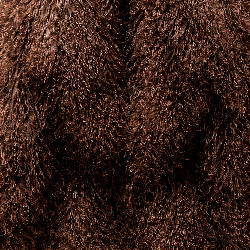 Close-up of brown Mongolian fur coat showing dense curly shearling texture – UK women’s winter outerwear