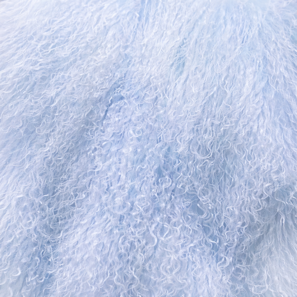 Close-up of light blue Mongolian fur coat showing dense curly shearling texture – UK women’s winter outerwear