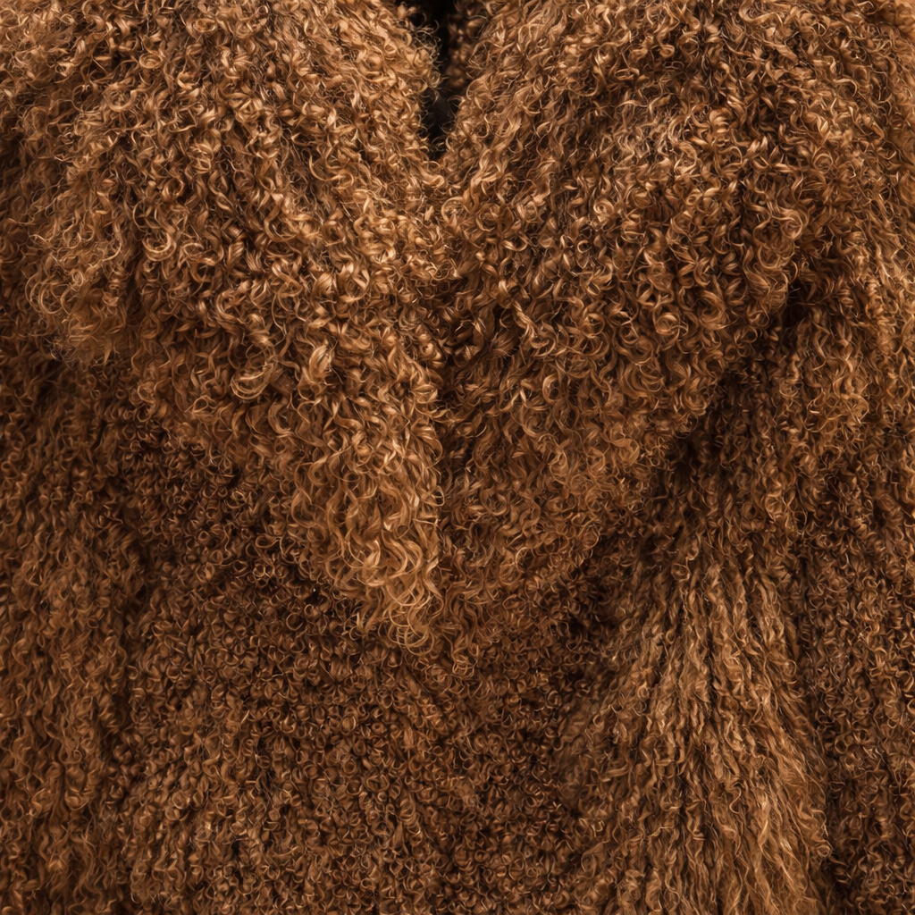 Close-up of mocha brown Mongolian fur coat showing dense curly shearling texture – UK women’s winter outerwear