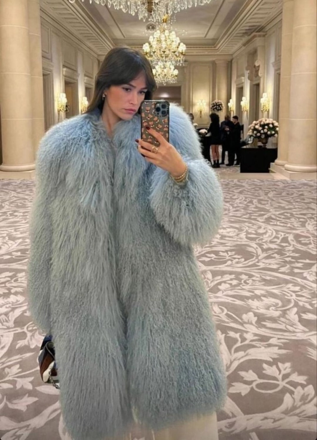 Close-up of mid length Mongolian fur coat showing dense curly shearling texture – UK women’s winter outerwear