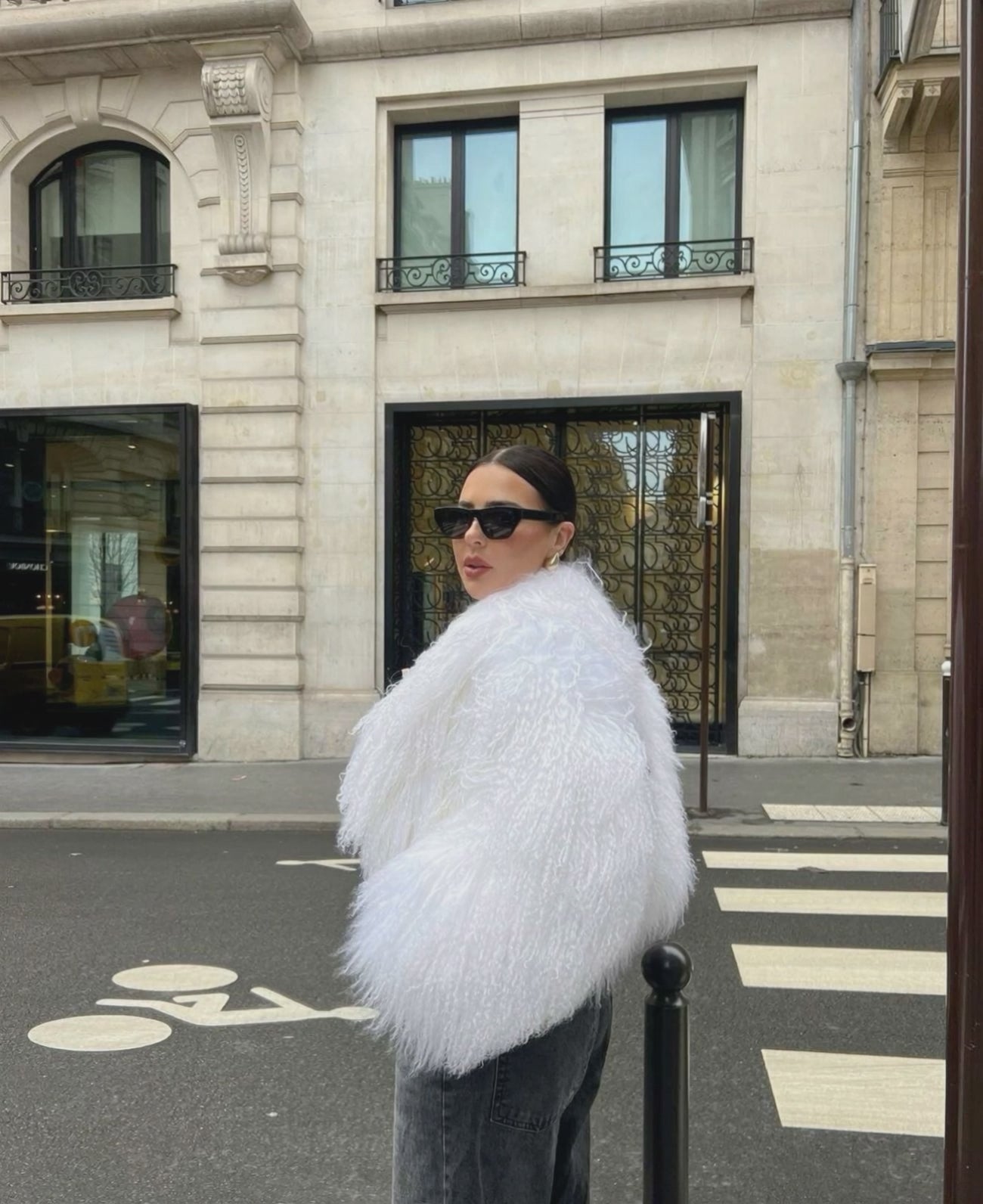 Close-up of white cropped Mongolian fur coat showing dense curly shearling texture – UK women’s winter outerwear