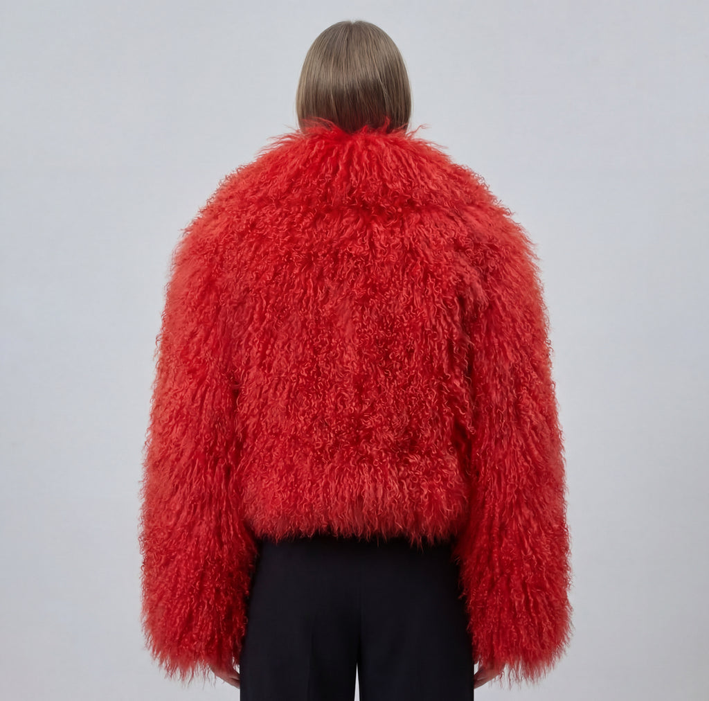 Model wearing a cropped red Mongolian fur coat with dense curly shearling texture – UK women’s winter outerwear