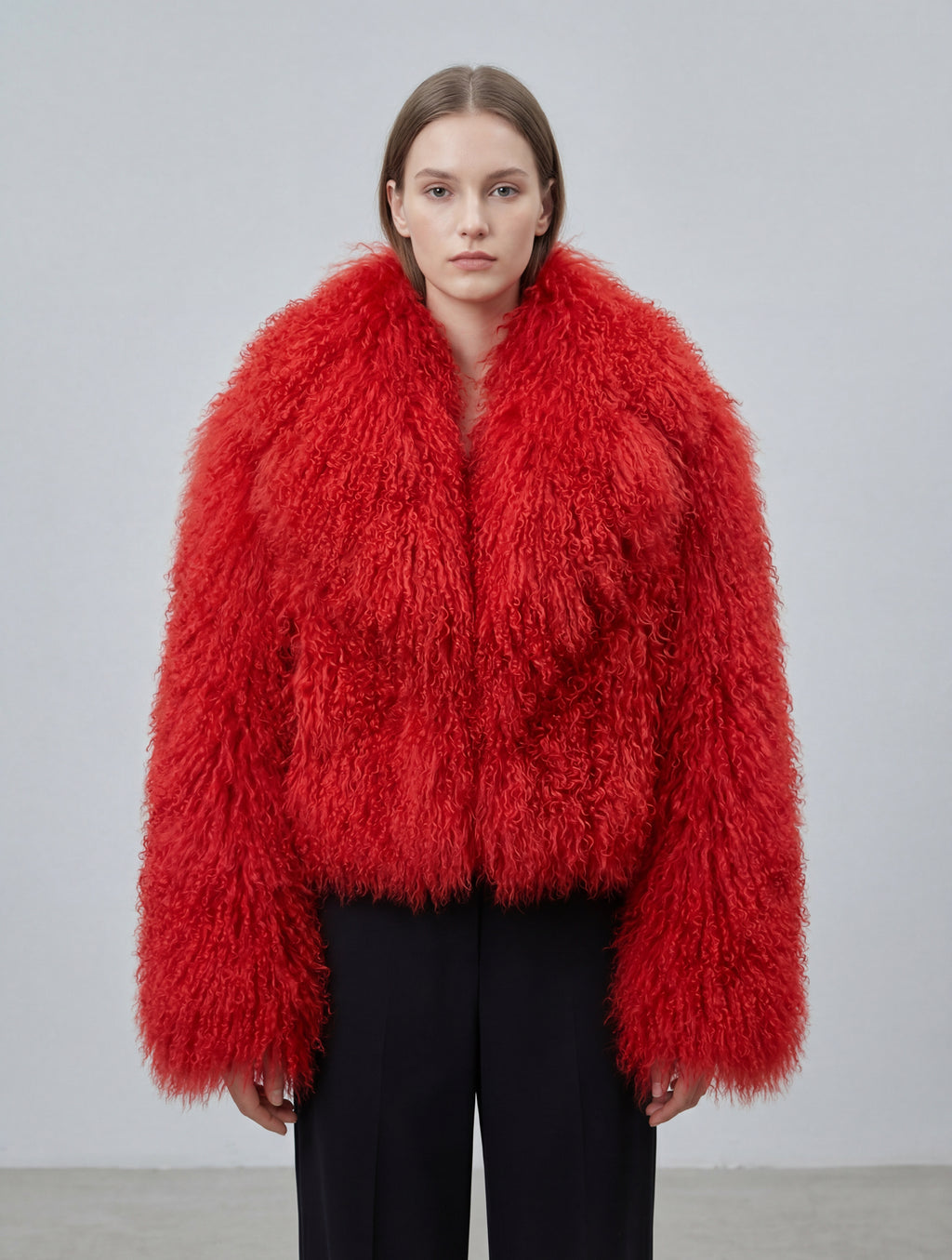 Red cropped Mongolian lamb fur jacket with dense curly texture, long sleeves, and plush volume