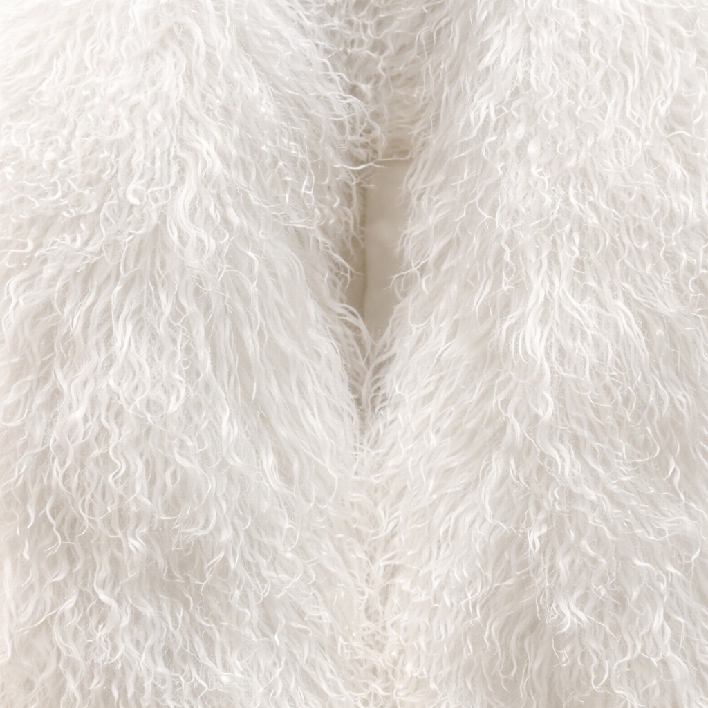 Close-up of white Mongolian fur coat showing dense curly shearling texture – UK women’s winter outerwear